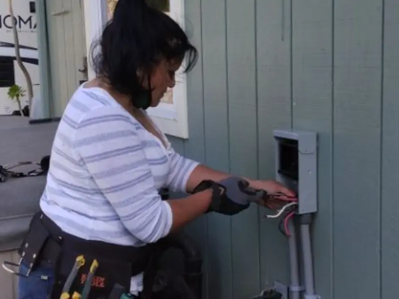 Licensed electrician wiring an exterior subpanel in Rowlett